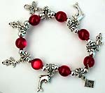 Bali silver and red color beaded stretchy charm bracelet with multi patterns, 2 dolphins, flower cross, 3 flowers and arrow in heart 