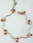 Wavy strip forming fashion bracelet with red yellow color beads embedded
