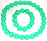 Multi rounded green plastic beads forming stretchy fashion necklace and bracelet set