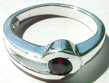 Cut -out mini loop pattern design sterling silver ring with a rounded red cz stone set in middle