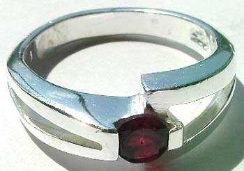 Carved-out knot lock design sterling silver ring holding a rounded red cz stone at center