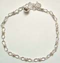 Multi flower pattern forming sterling silver anklet with a bell attached at the end