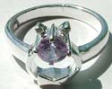Bow-tie pattern design sterling silver ring holding a rounded LIGHT PURPLE cz stone in middle