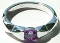 A rounded dark purple cz stone embedded carved-out triangle pattern design sterling silver ring