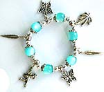 Blue beaded strecthy charm bracelet with butterfly, Apolo angel, and leaf pattern 