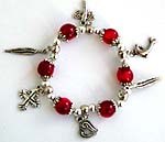 Red beaded strecthy charm bracelet with cross, leaf, dolphin and heart pattern