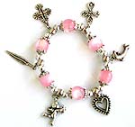 Pink color beaded strecthy charm bracelet with cross, leaf, dolphin, heart and Apolo angel pattern 