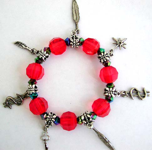 Child charm bracelet - Multi red color facet beads and silver beaded charm stretchy bracelet with figures, leaf, cross, triangle, key and dollar sign