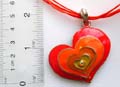 Multi orange strings fashion necklace with a orange enamel color beaded curved heart love pendant
