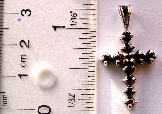 Fancy cross pendant with garnet gemstone in prong set      
