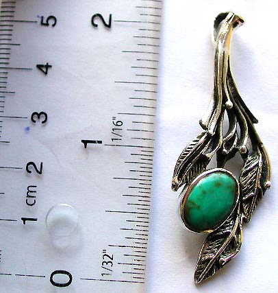 925. sterling silver pendant in carved-out leaf pattern design with an oval shape green turquoise stone embedded        

