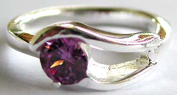 925. sterling silver ring with carved-out double wavy pattern holding a rounded amethyst stone in middle 

 
  



 
   