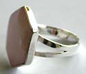 Central close knot pattern design sterling silver ring with a mini rounded pink color cz stone inlaid