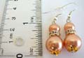Fashion fish hook earring with double orange color imitation pearl beads holding a cz ring central decor, gloden bead cap set on top and bottom of the second bead