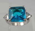 Fine cutting aqua cubic zirconia ring with triangular clear cz on each side, made rhodium plated and in brass base
