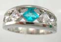 High rhodium plasted polish ring with diamond aqua cz and four clear cz set in middle 