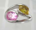 Rhodium plated fashion ring holding pink and yellow cz stones in middle, brass bass