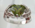 Cz ring in rhodium plated with olive cz central design and X-shaped aside with clear cz embedded, brass bass