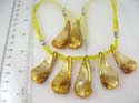 Fashion seashell jewelry set. Pearl-shaped yellow seashell pendant necklace with lobster clasp paired with same design fish hook earring 