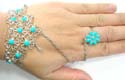 Fashion slave bracelet with imitation turquoise beads embedded in cut-out flower shape and silvery water-drop pattern decor