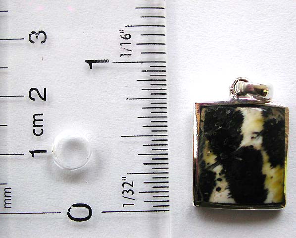Sterling silver pendant in square pattern design with black spotted, white stone