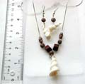 Fashion necklace and earring set with wooden beads chain holding a white spiral seashell pendant