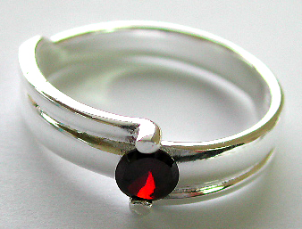Sterling silver ring with holding a rounded red garnet stone