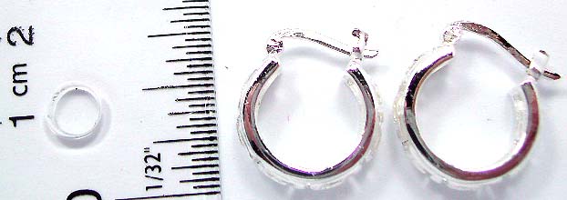 Crescent moon shape design hoop earring in stamped 925. sterling silver setting with carved-out silver sand covered Z shape pattern decor along        