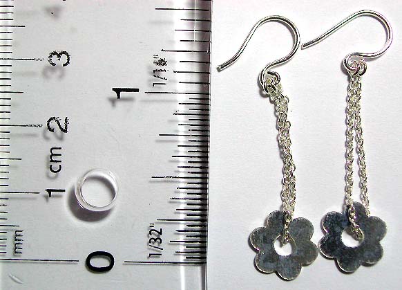 Sterling silver earring with chain loop holding a flower pattern on bottom        
