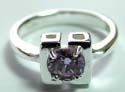 Sterling silver ring with open-square pattern holding a rounded light purple cz stone in middle