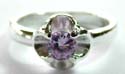 Sterling silver ring with a rounded kight / dark purple color amethyst stone embedded flower pattern decor at center