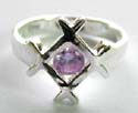 Sterling silver ring with carved-out "number sign" pattern decor holding a rounded light / dark purple cz stone at center