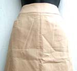 Muddy yellow fashion lady's skirt with polyester inner layer; medium length; two front pockets; zipper back closure; open on the back bottom