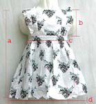 One piece through kid's skirt; white or green color; flower edge cut; floral pattern decor; two hip pockets; crisscross back for adjustable fit; button-up back closure