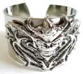 Fashion bangle in plain wide band design with fear monster pattern decor at center