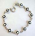 Multi enamel black and white diamond pattern forming fashion bracelet, with toggle jewelry clasp for convenience closure