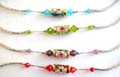 Fashion bracelet with curved long strip and diamond shape color beads inlay holding a cylinder shape handmade enamel cloisonne   flower bead at center, assorted color randomly pick