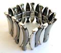 Fashion stretchy bracelet in multi black and silvery curved fish strip design 