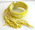 Fashion bracelet bangle in multi yellow and white beaded strings design with multi beaded string dangles suspended at the end