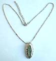 Fashion necklace with beaded chain holding a multi mini shiny beads inlaid long elliptical metal pendant at center 