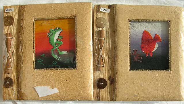 Rectangular handmade photo album with assorted animal central design and a rope on side, made of natural material such as banana leaf, mulberry papers, recycling papers and more