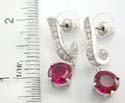 Brass base clear cz J shape studs earring holding a ruby cz at the bottom