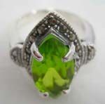 Stamped sterling silver ring motif marcasite leaf shape holding a green 