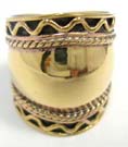 Trendy bronze ring with wave design framing solid, sheen center 