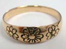 Three daisy flowers imprinted into bronze band 
