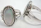 Antique designed 925. sterling silver ring with large oval, opal colored gem in center