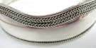 Double braided border along top of thick 925. sterling silver bangle bracelet and single braid band at bottom
