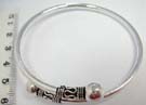 Trendy 925. sterling silver bangle bracelet with large ball on end held by wave and small circle bead decor