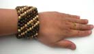 Crafted, brown colored beaded bracelet with wide band 