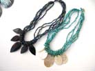 Multi beaded string necklace with large seashells at base